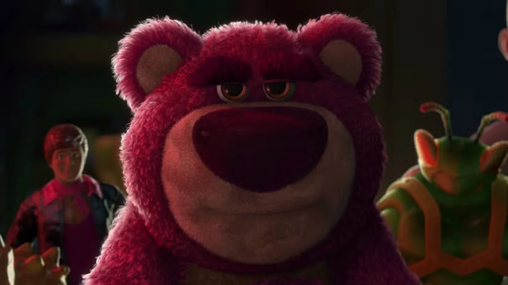 Lotso Huggin' Bear Close up of a Fuzzy Purple Bear with a Large Nose Looking Toward the Camera in a Dark Scene