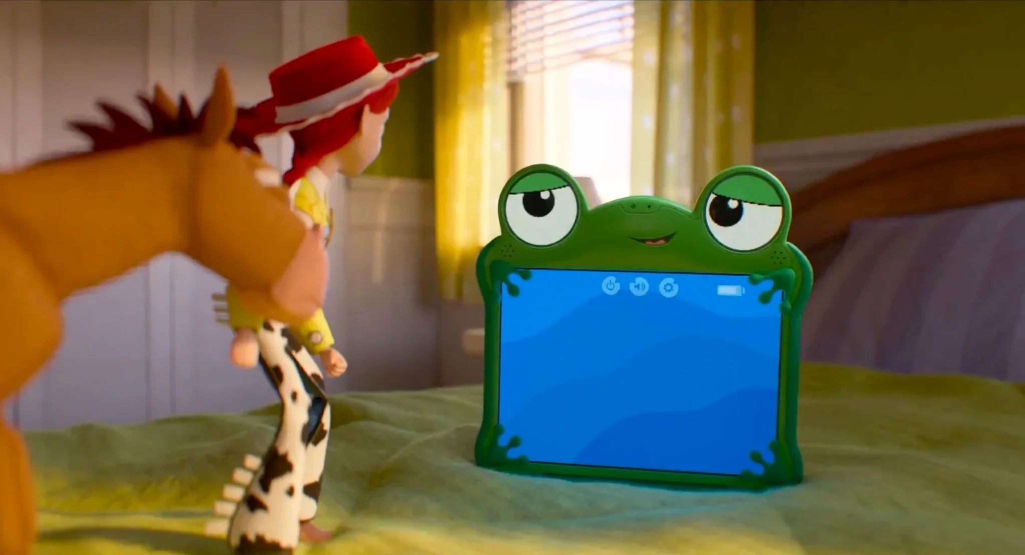 Lilypad Toy Story a Green Frog themed Tablet Toy with Big Eyes Sits on a Bed Facing a Child in a Red Hat Who Watches from the Left in a Cozy Bedroom