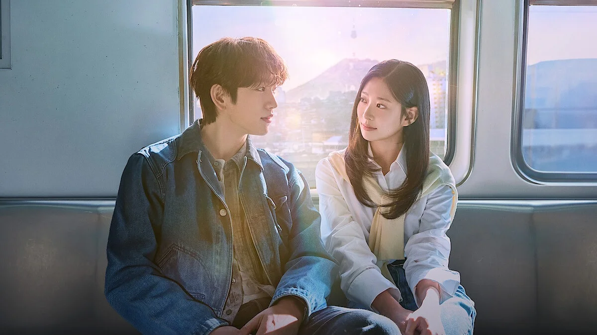 Shining 2026 Kdrama Two Young Adults Sit Side by Side on a Train Gazing at Each Other As Sunlight Streams Through the Window