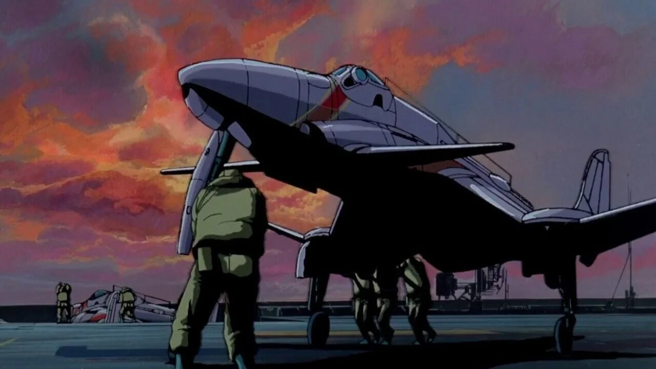 Royal Space Force the Wings of Honnêamise Military Personnel in Green Uniforms Inspect a Sleek Futuristic Fighter on an Aircraft Carrier at Sunset