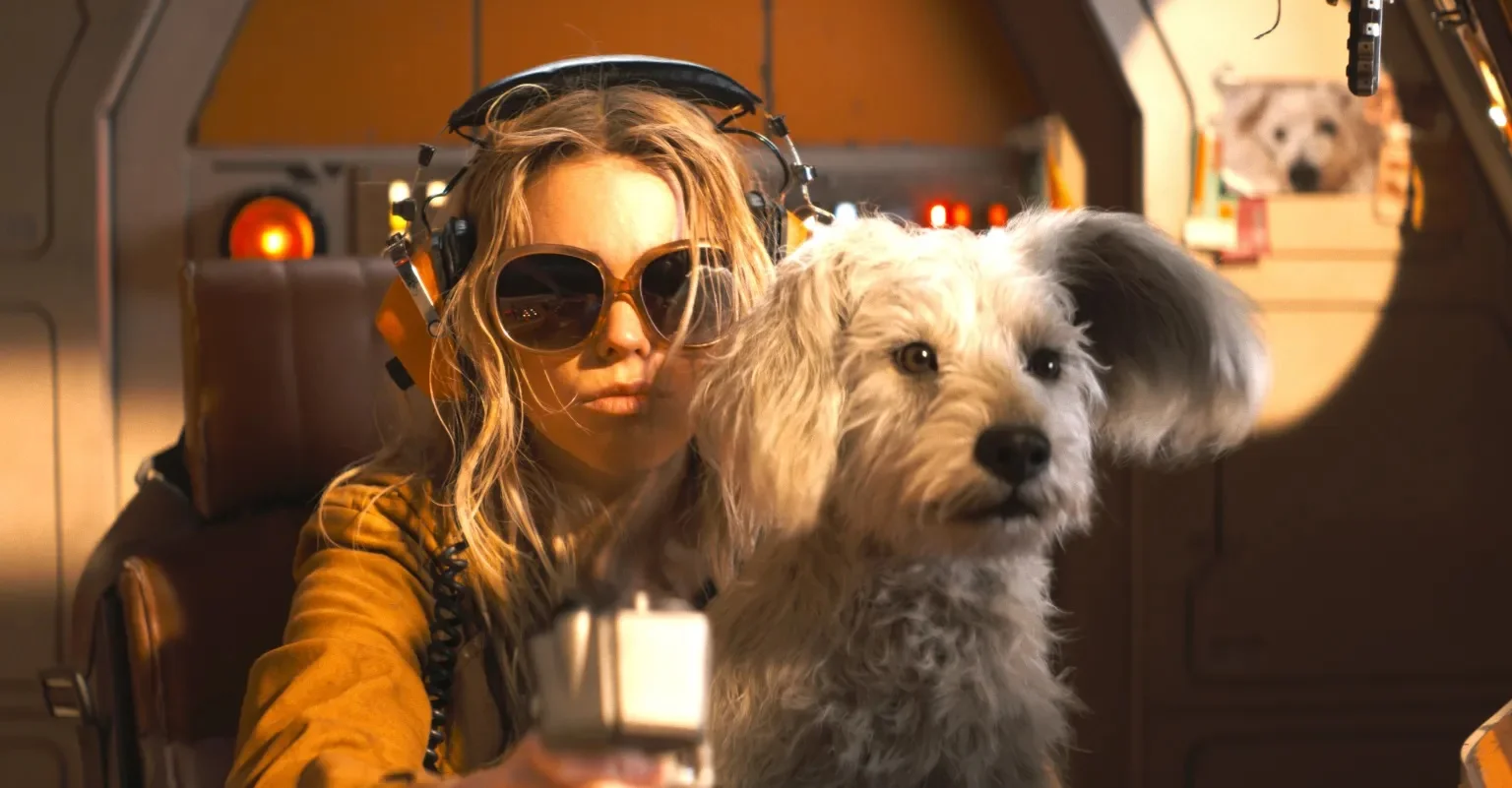 Supergirl Woman Wearing Oversized Sunglasses and a Headset Sits in a Spacecraft Cockpit with a Fluffy White Dog Beside Her